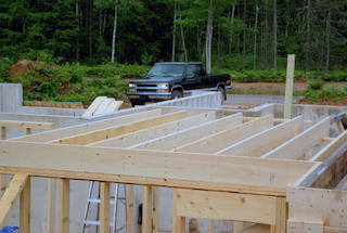 A picture showing 2x10 floor joist nailed through thr rim joist.