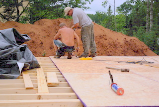 A picture of 3/4 in. osb board being laid.