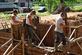 Men pouring a concrete foundation