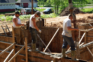 Men pouring a concrete foundation Men pouring a concrete foundation