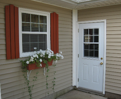 A picture of a vinyl window and a steel door