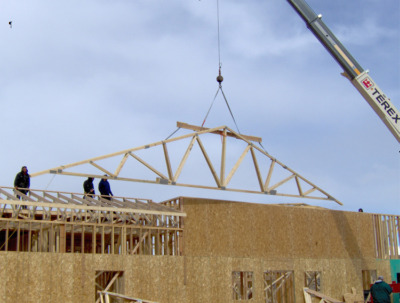 Roof trusses being installed by a crane